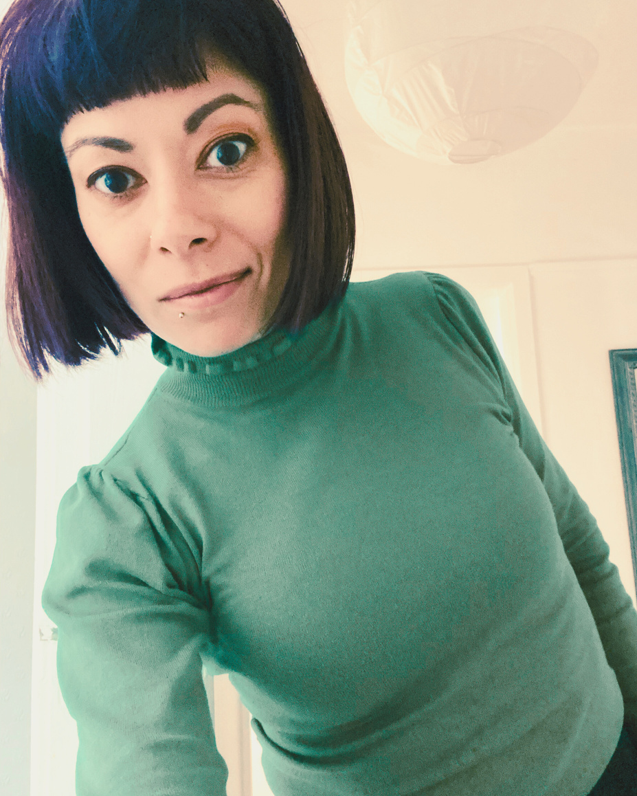 a person in a green sweater taking a selfie
